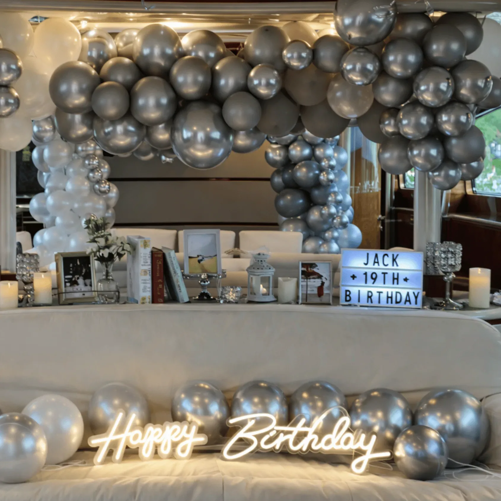 Silver balloon arch birthday setup on yacht