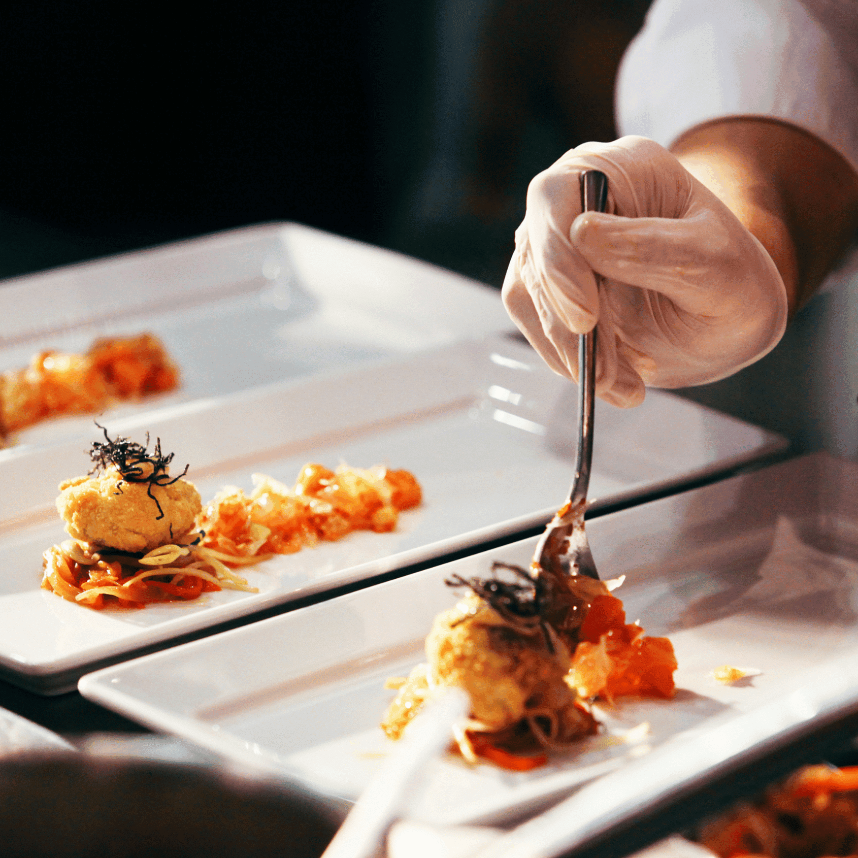Chef plating fine dining course on board