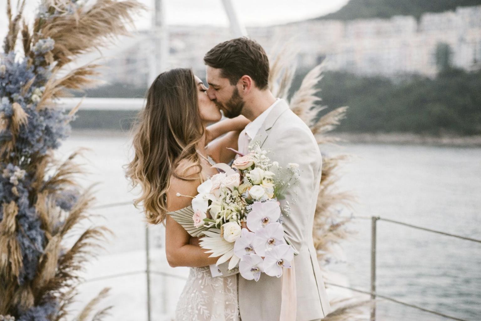 small yacht wedding miami with couple and guests on deck at sunset