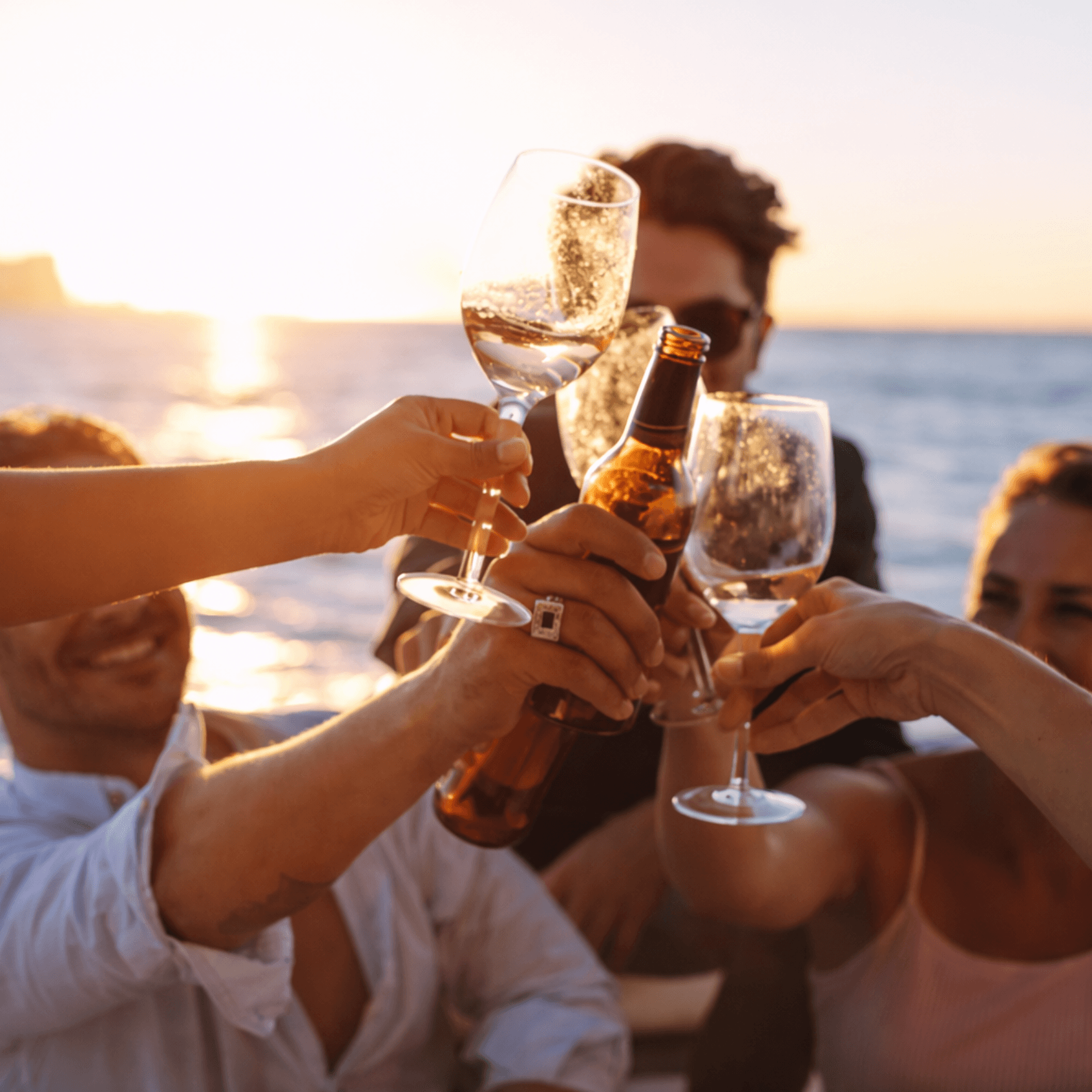 Sunset cheers with drinks on yacht